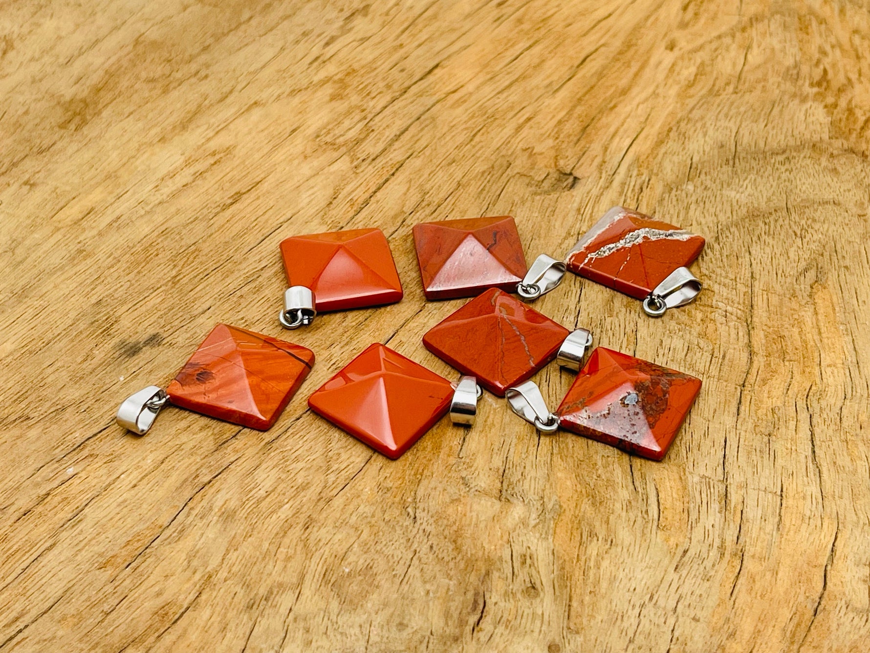 Red Jasper pyramid gemstone pendant from GemstoneGO featuring a natural red jasper stone on a silver chain.