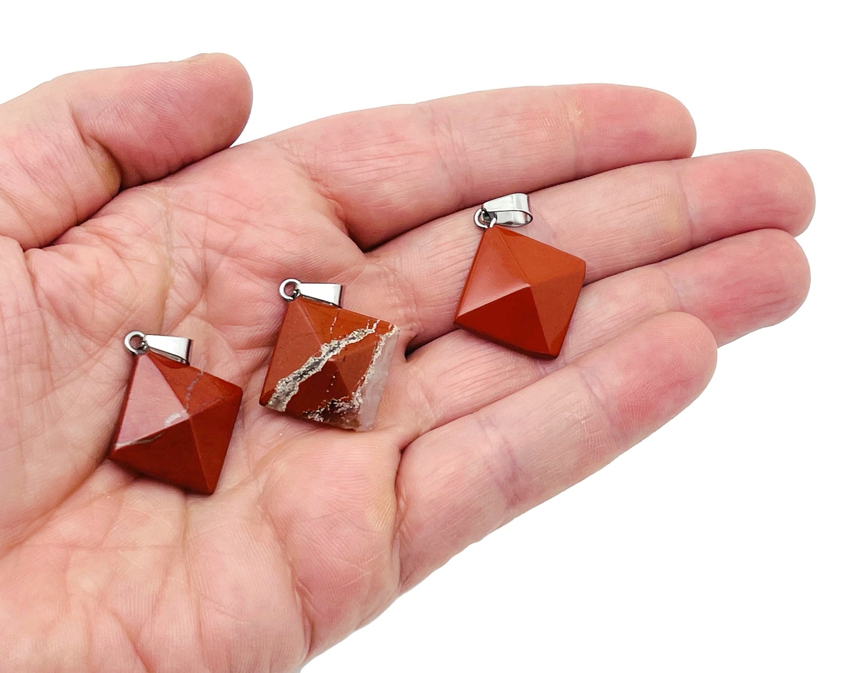 Red Jasper pyramid gemstone pendant from GemstoneGO, showcasing a vibrant natural red Jasper pyramid pendant with intricate details.
