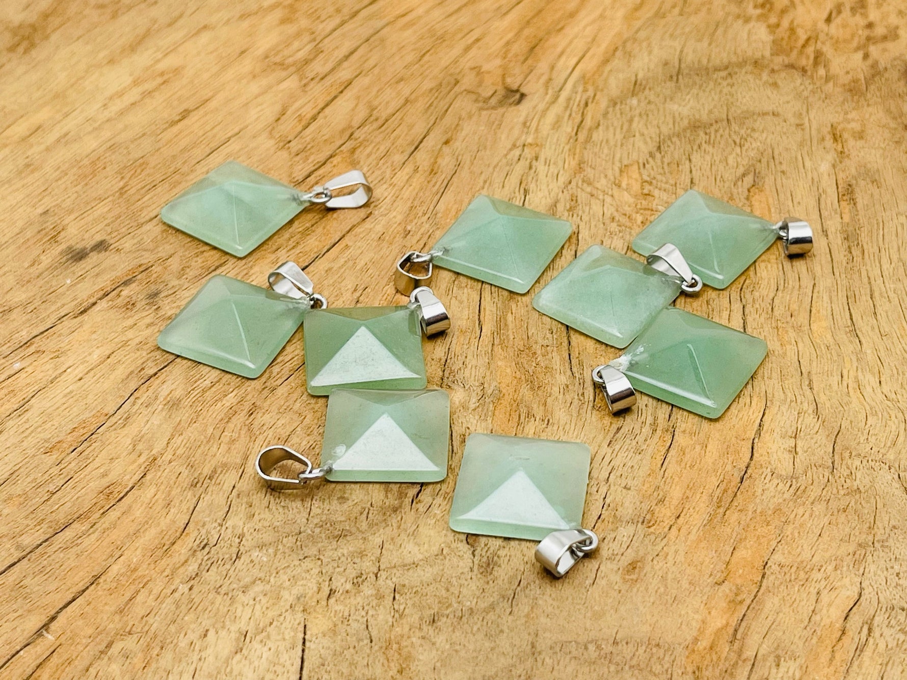 Aventurine pyramid gemstone pendant from GemstoneGO, featuring a natural green aventurine stone with a pyramid shape, on a jewelry chain.