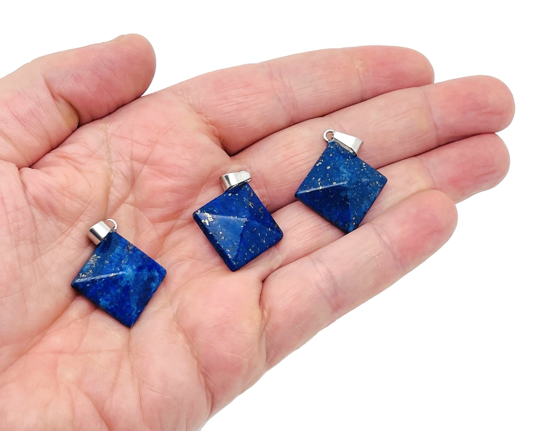 Lapis Lazuli pyramid gemstone pendant from GemstoneGO featuring a natural blue gemstone with gold-colored matrix details.