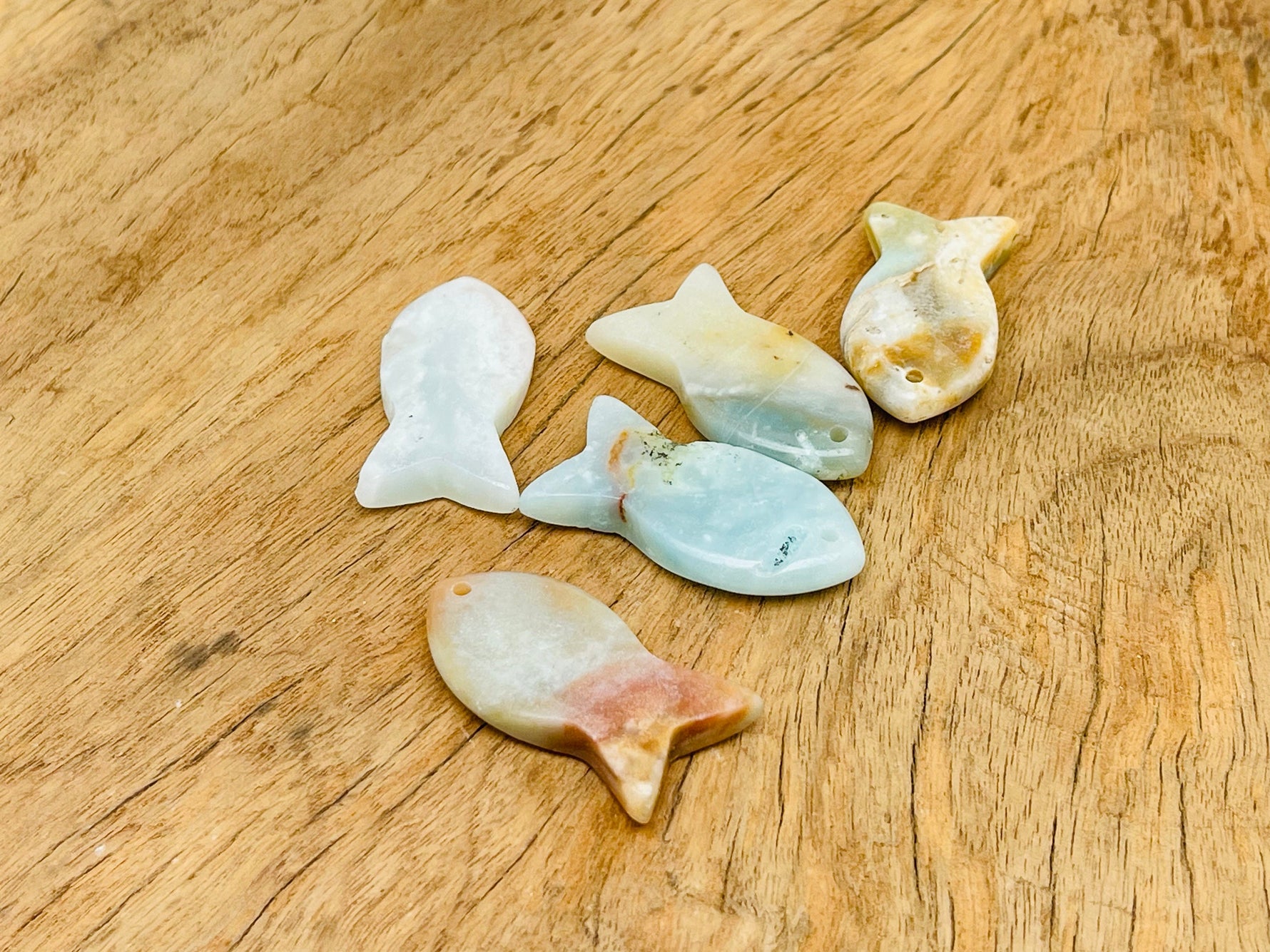 Amazonite fish gemstone pendant featuring a Pisces zodiac hole crystal from GemstoneGO, showcasing vibrant blue-green stone and detailed fish design.