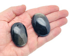 Golden Sheen Obsidian palm gemstone spa stone from GemstoneGO, showcasing a polished, shiny black and gold-toned obsidian palm stone.