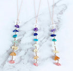 7 Chakra Crystal Necklace by GemstoneGO featuring silver and gold accents with colorful chakra gemstones on a chain