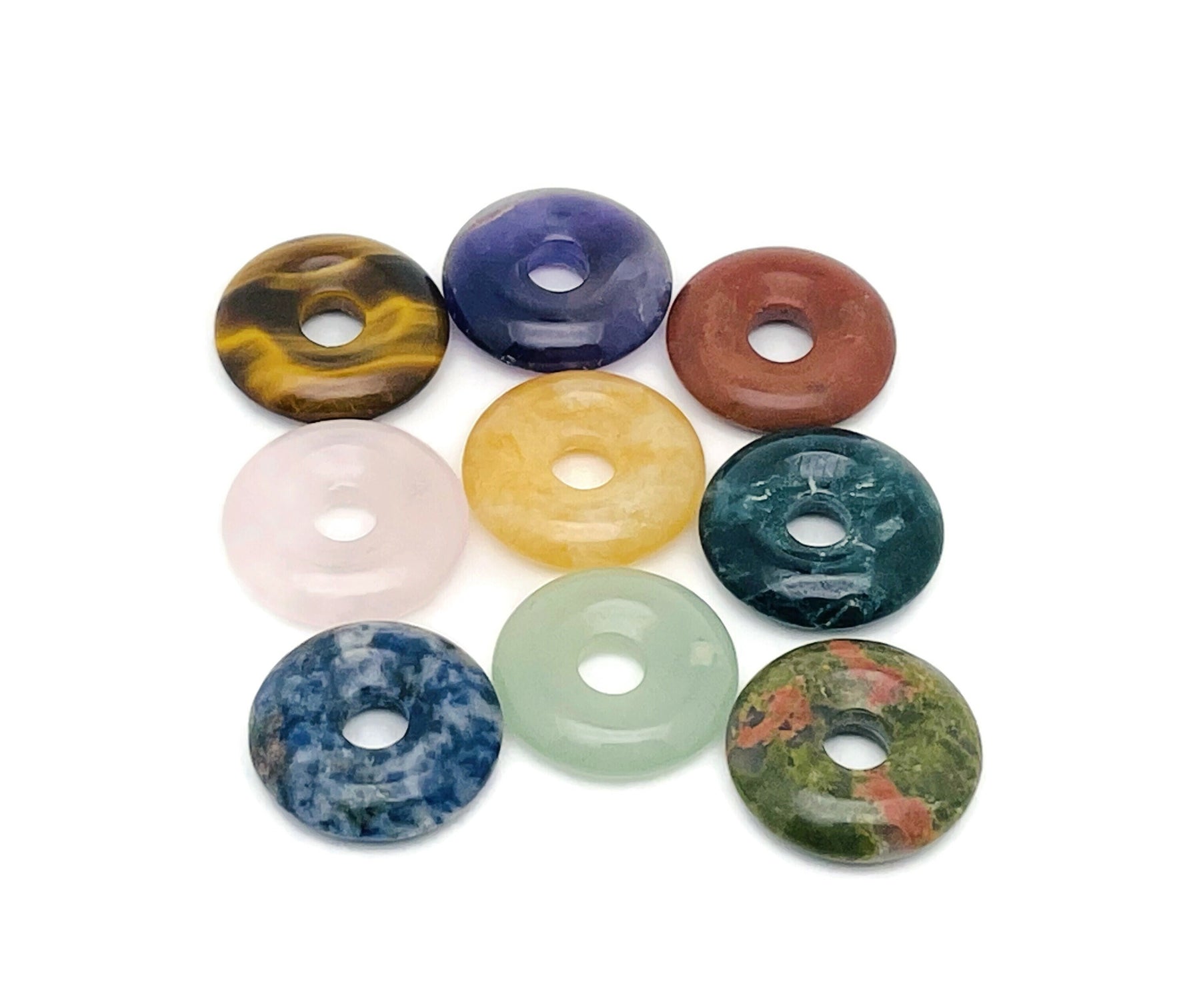 Crystal donut gemstone from GemstoneGO, 20mm Pi Stone lucky safety crystal with colorful mixed stones on a white background.