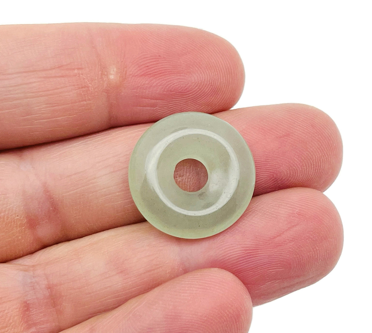 Aventurine crystal donut pendant, 20mm Pi stone from GemstoneGO, showcasing green gemstone with smooth, polished surface.
