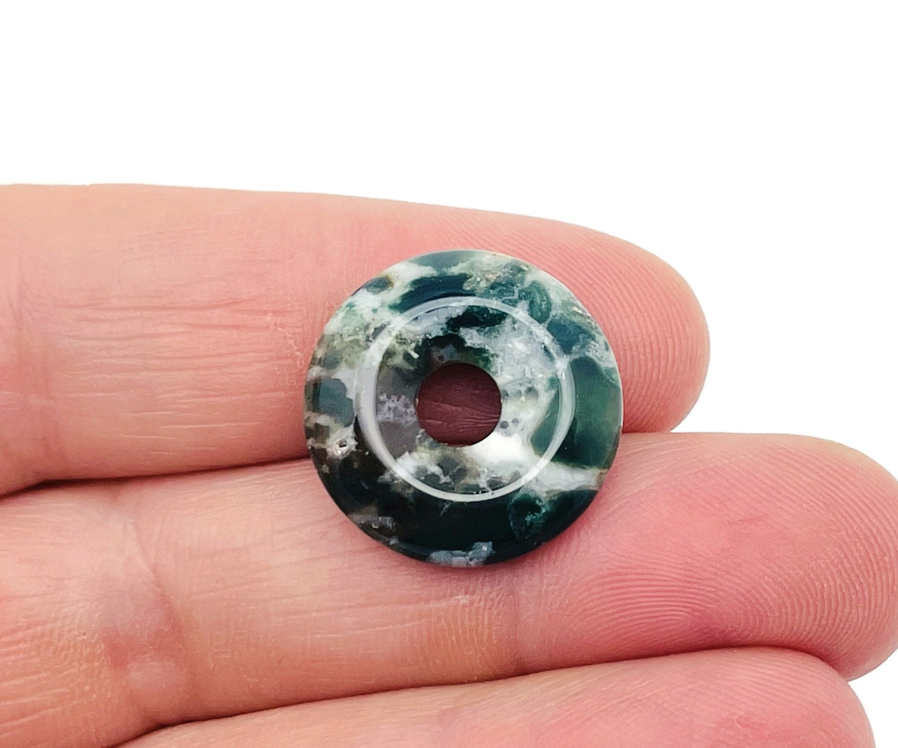 Moss agate crystal donut pendant, 20mm Pi stone from GemstoneGO, featuring green and brown natural gemstone patterns.