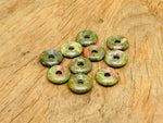 Unakite crystal donut pendant, 20mm Pi stone from GemstoneGO, showcasing pink and green mineral patterns on a white background.