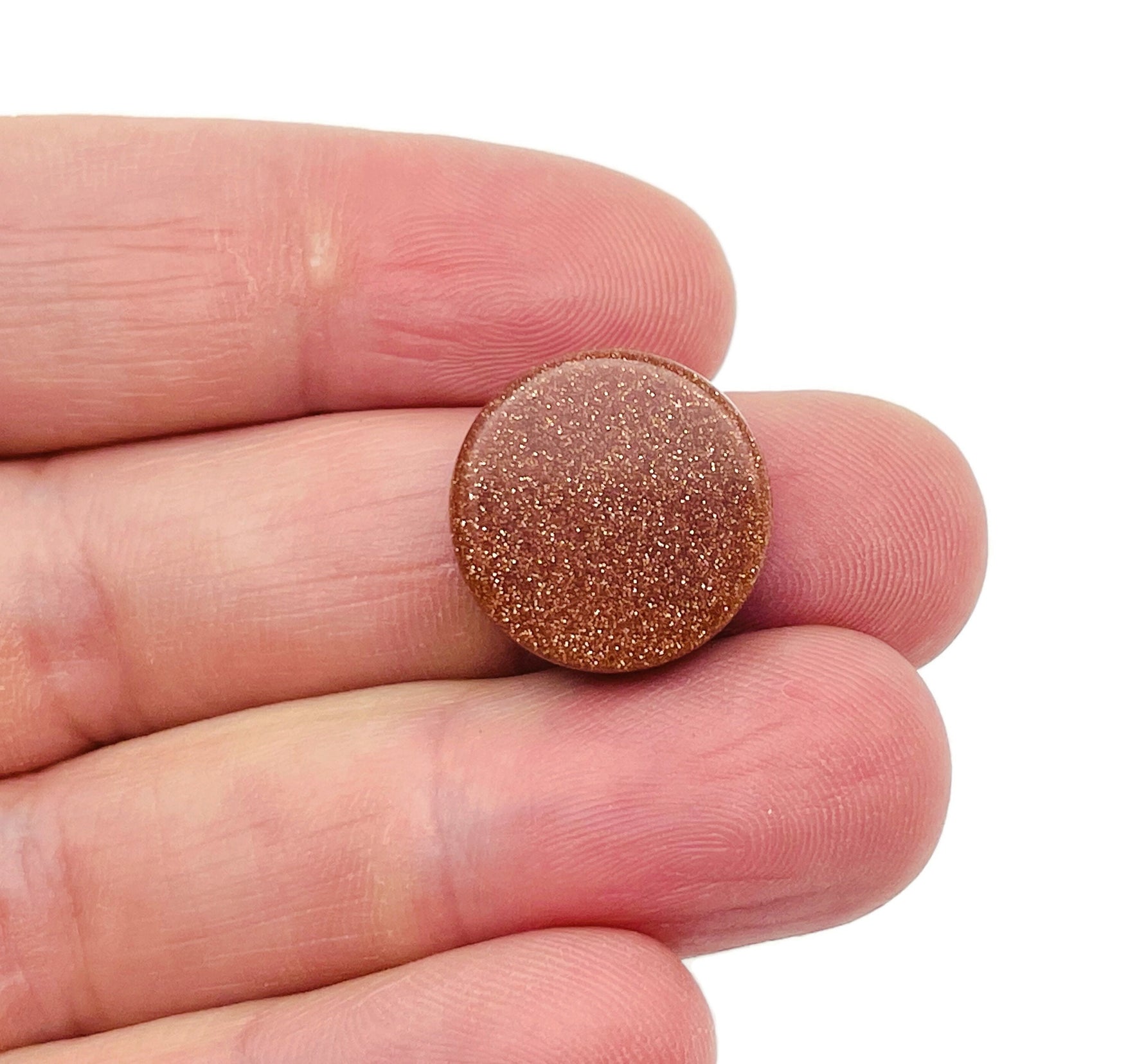 Round Goldstone flat gemstone slab from GemstoneGO showing a shimmering, sparkly gold-colored crystal surface.