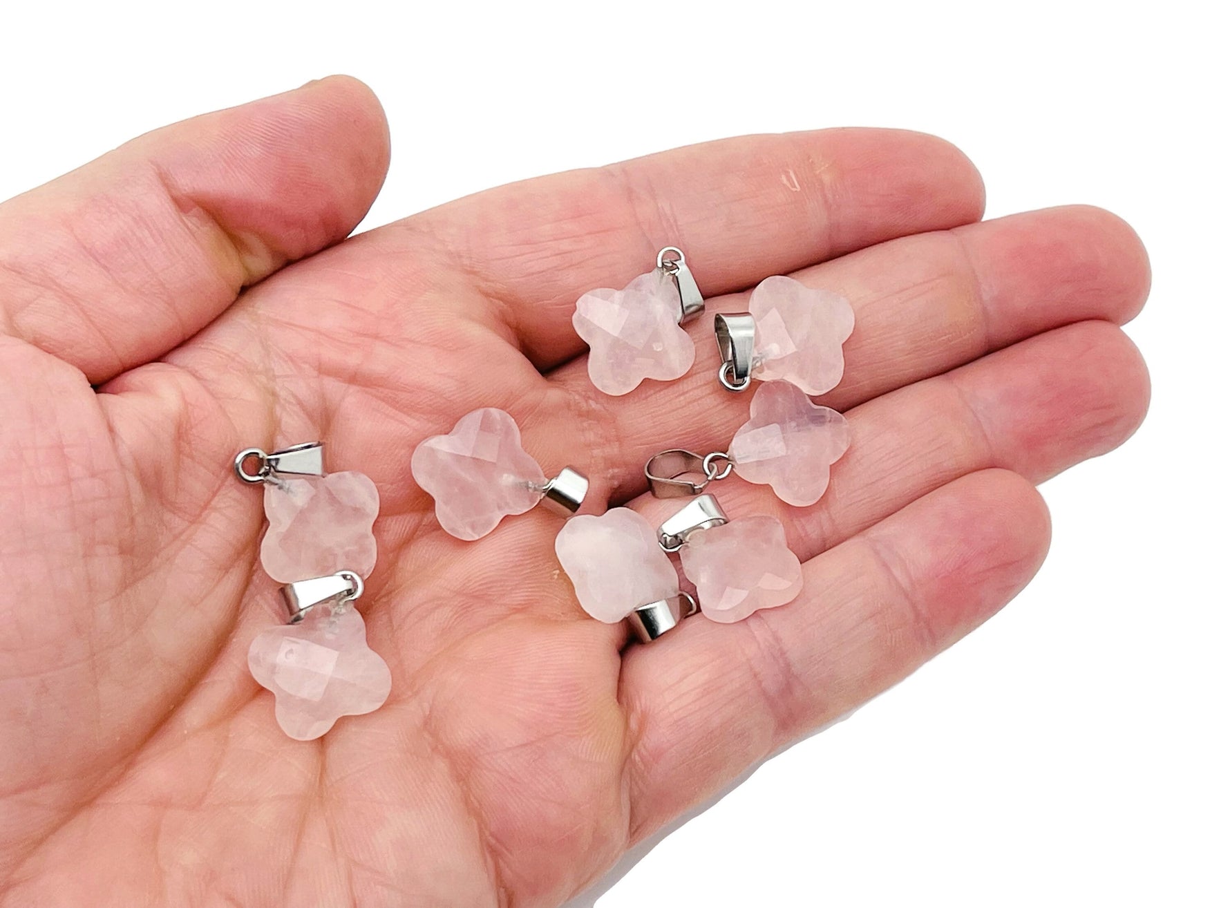 Rose quartz four-leaf clover crystal pendant from GemstoneGO, perfect for DIY jewelry making, showing a pink gemstone pendant with a silver bail.