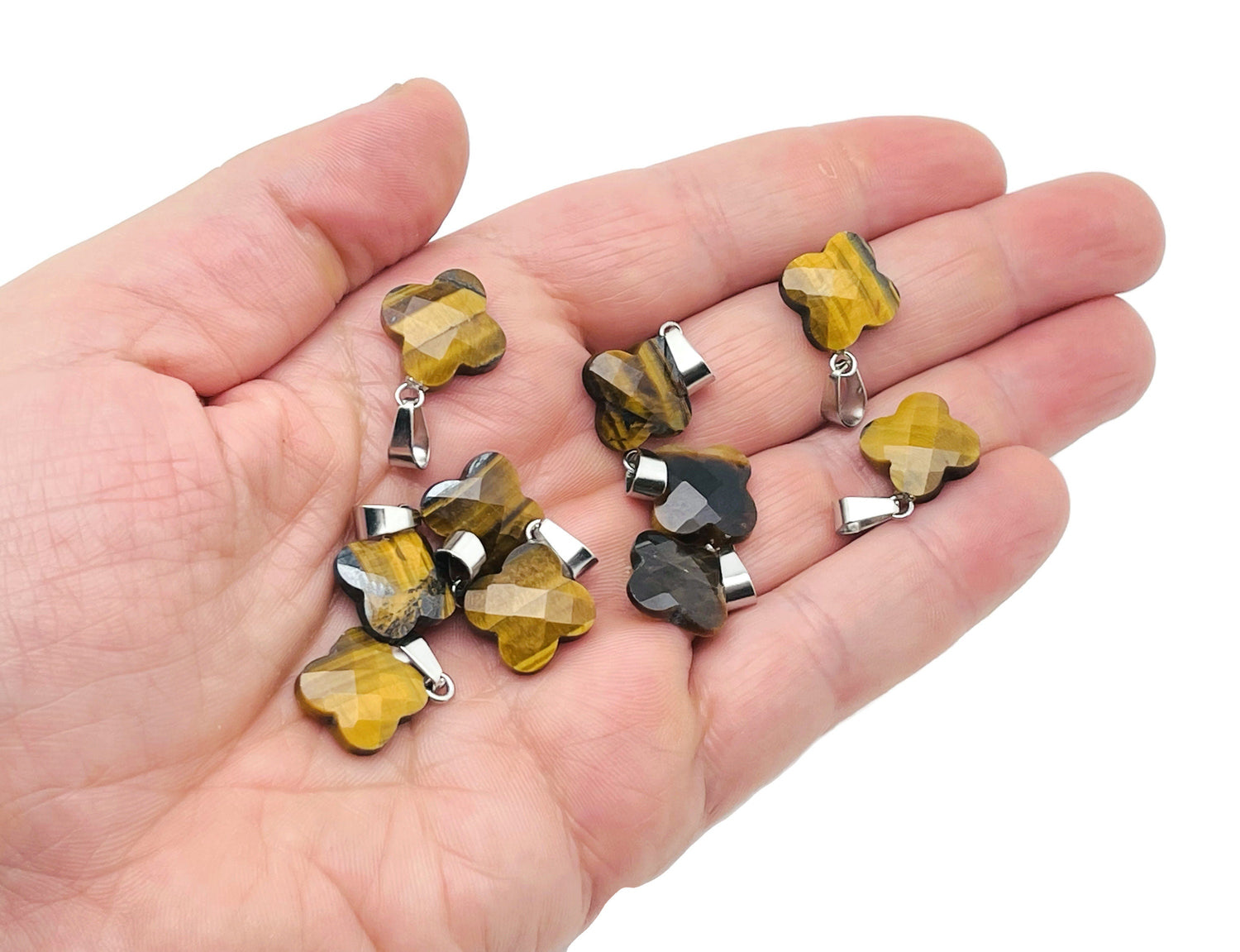 Tiger Eye four-leaf clover crystal pendant from GemstoneGO, showcasing a polished gemstone with a silver bail for jewelry making.