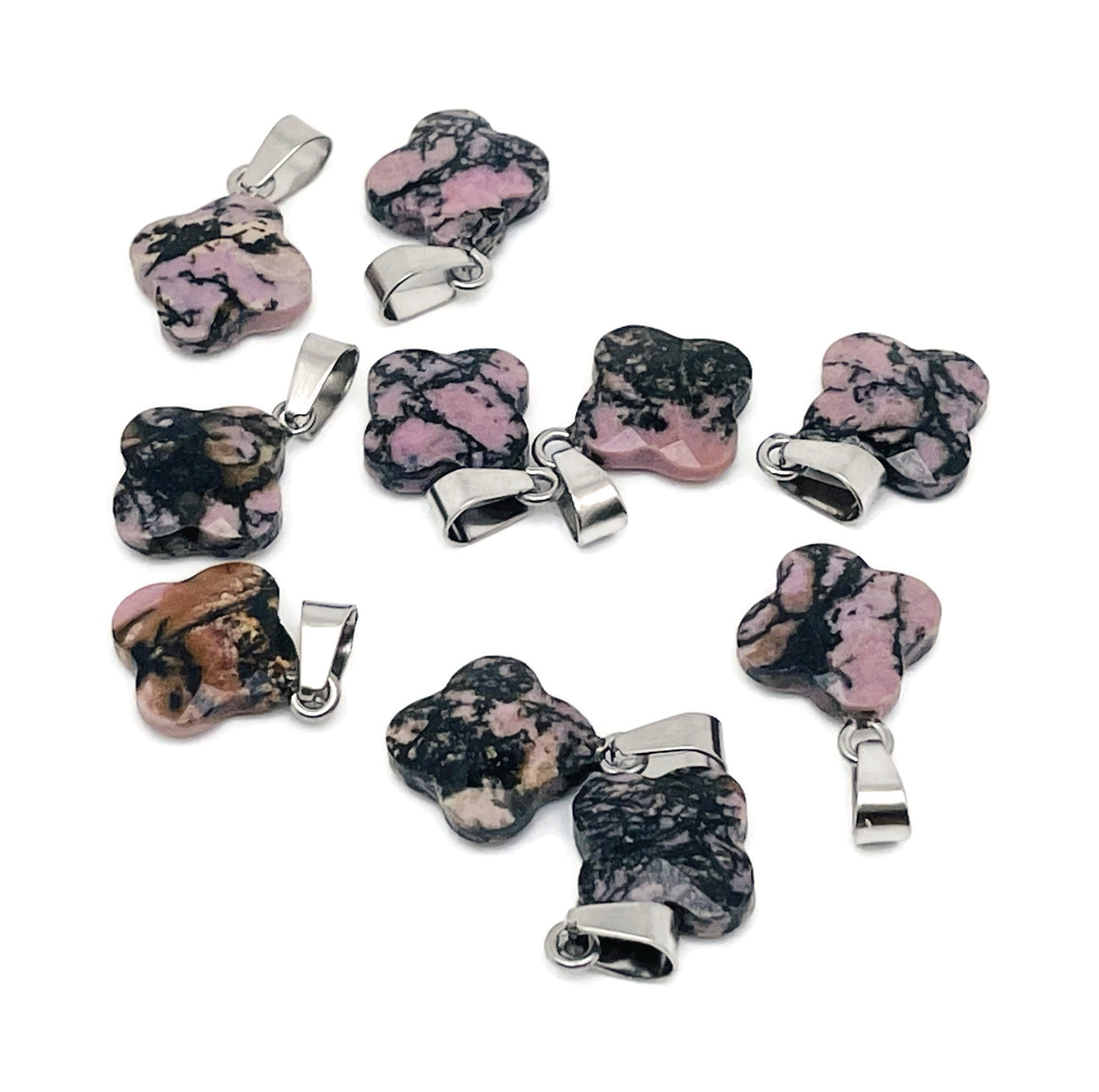 Rhodonite four-leaf clover crystal pendant from GemstoneGO for DIY jewelry making, featuring pink and black gemstone details.