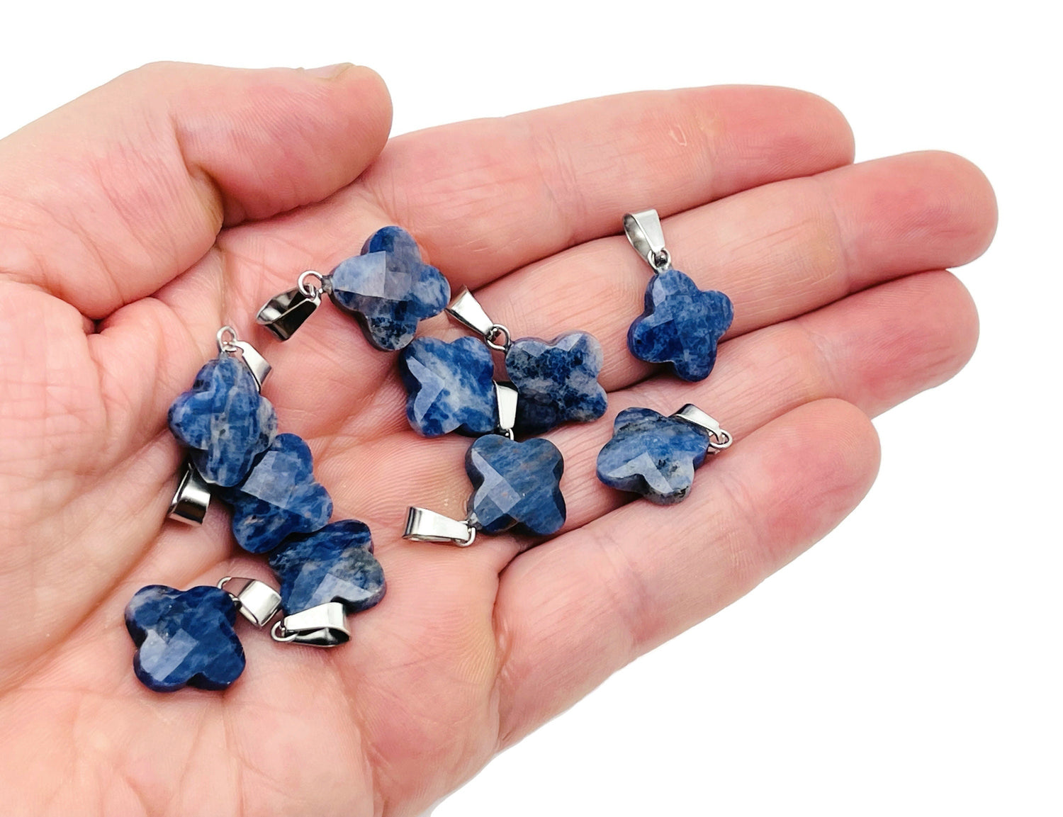 Sodalite four-leaf clover crystal pendant from GemstoneGO, suitable for DIY jewelry making, featuring blue and white gemstone details.