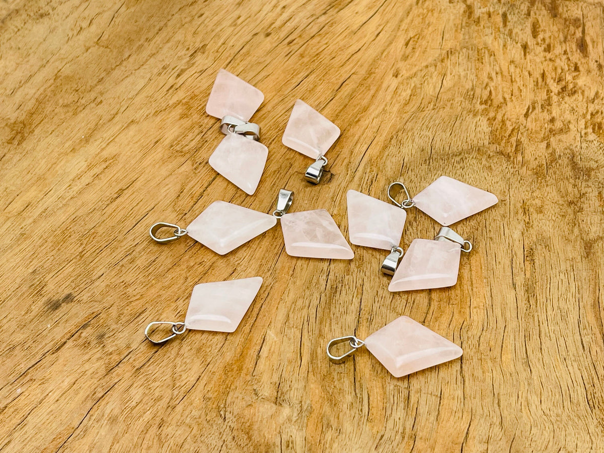 Rose quartz triangle gemstone pendant from GemstoneGO, featuring a geometric design and polished gemstone, on a silver chain.