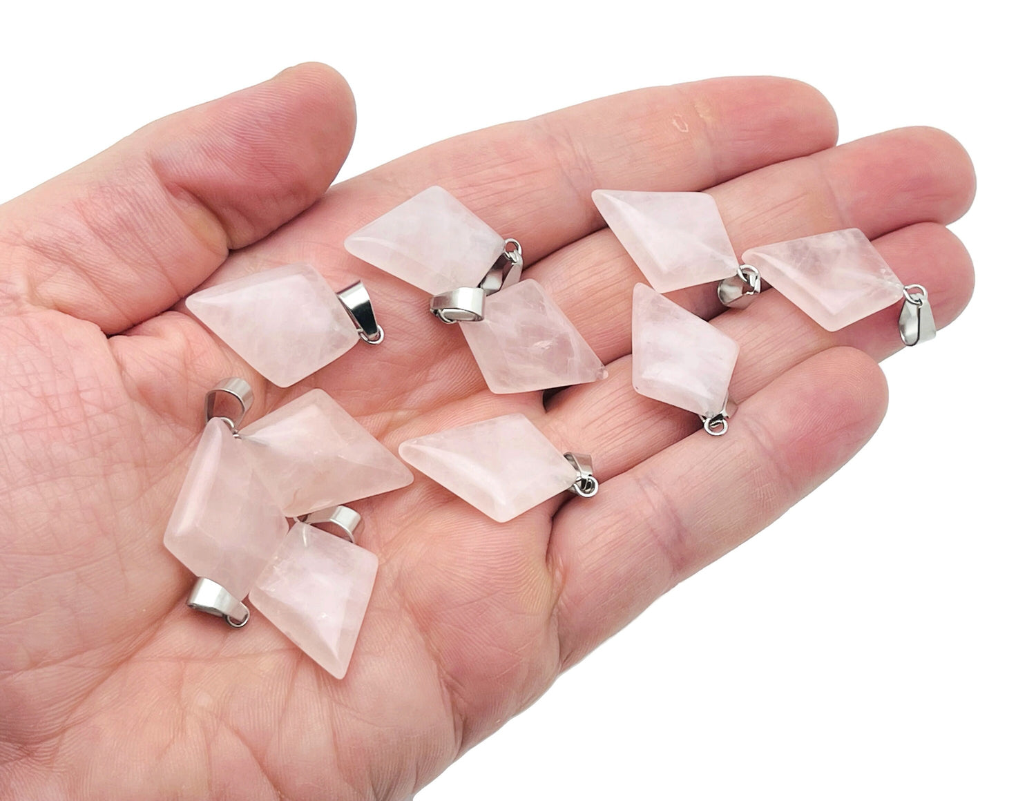 Rose quartz triangle gemstone pendant from GemstoneGO featuring a geometric design and polished finish.