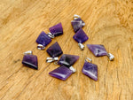 Amethyst triangle gemstone pendant from GemstoneGO showcasing a geometric purple stone on a silver chain.