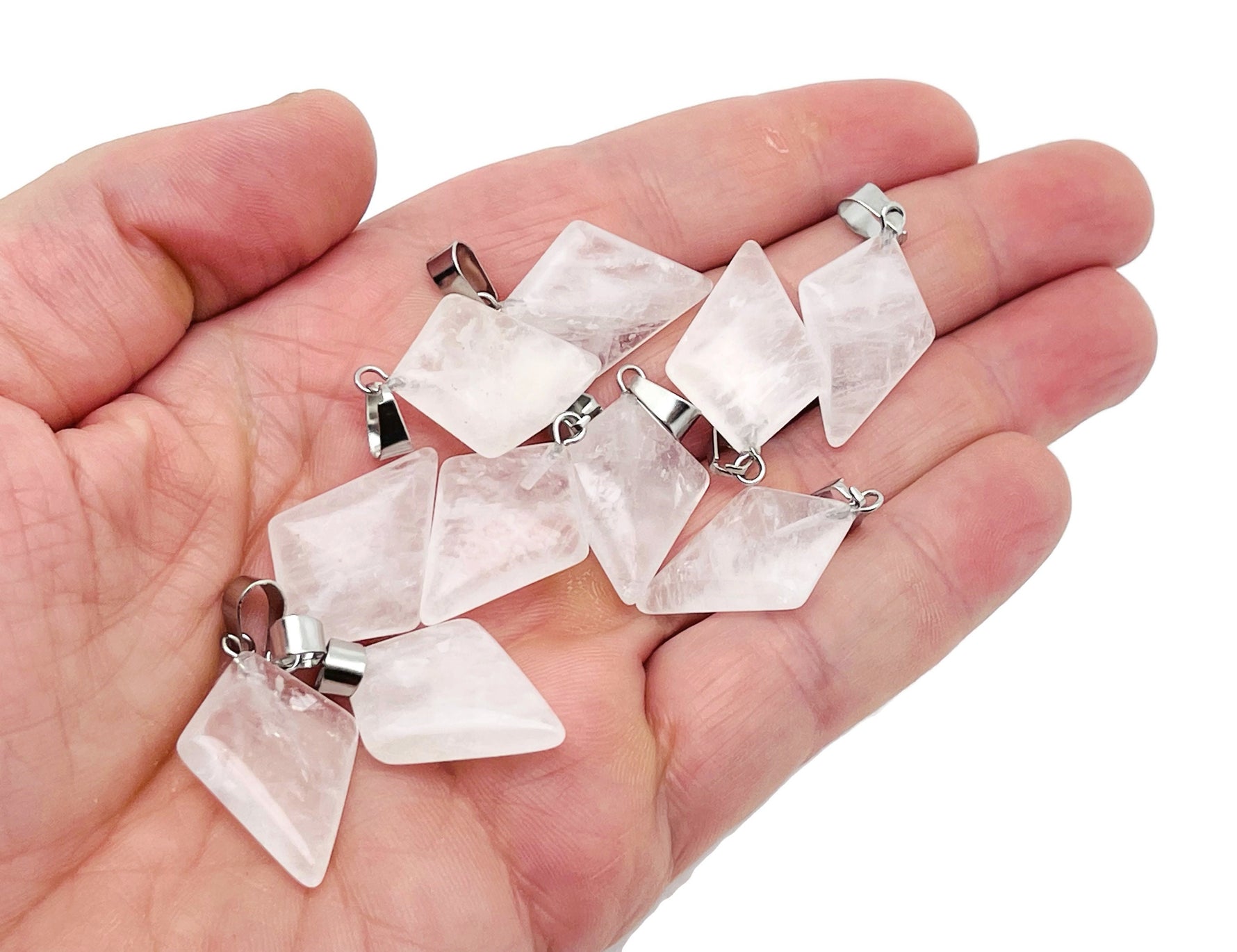 Clear quartz triangle gemstone pendant from GemstoneGO, featuring a geometric design and polished surface.