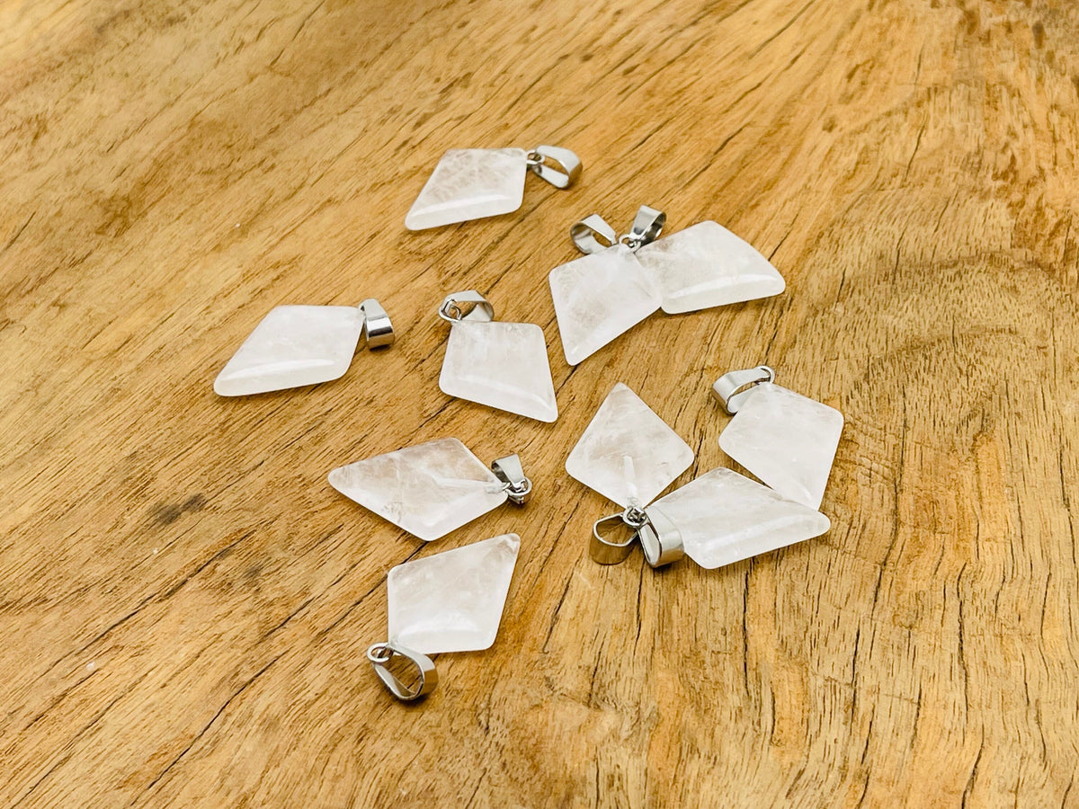 Clear quartz triangle gemstone pendant by GemstoneGO, featuring a geometric design and polished finish.