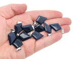 Blue Goldstone triangle gemstone pendant with geometric design, featuring a sparkling blue and gold-colored stone on a silver chain.