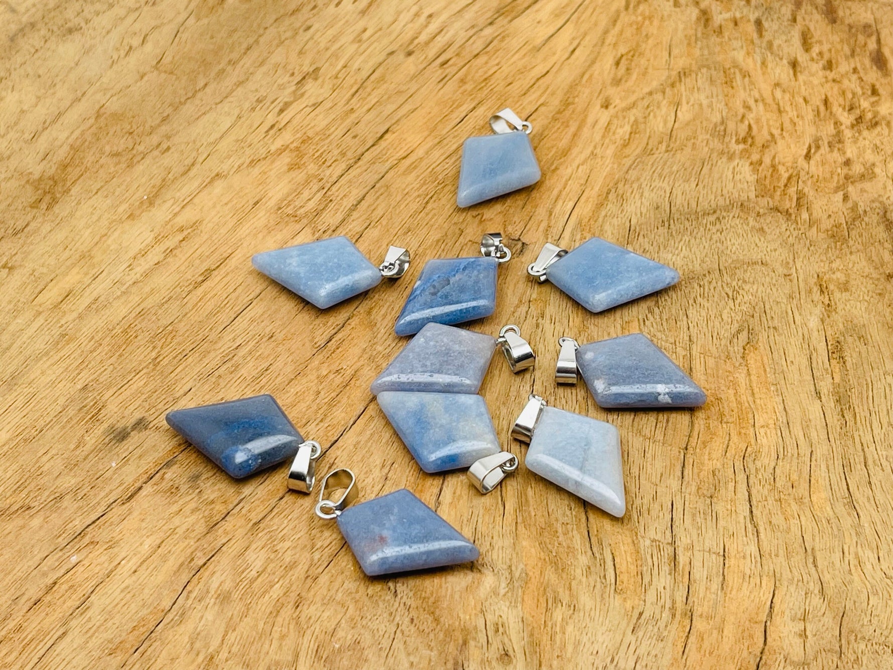 Blue aventurine pyramid gemstone pendant from GemstoneGO, showcasing a natural blue gemstone carved into a pyramid shape.