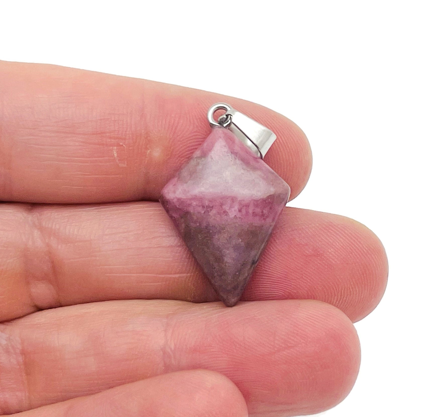 Rhodonite triangle gemstone pendant by GemstoneGO featuring a geometric design, displayed against a neutral background.
