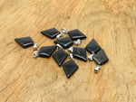 Obsidian triangle gemstone pendant with geometric design, showcasing a polished black gemstone on a silver chain.