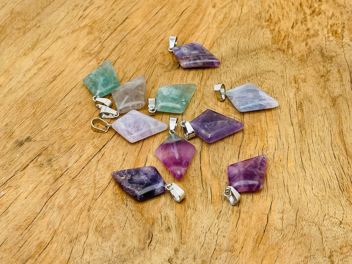 Fluorite triangle gemstone pendant with geometric design, featuring vibrant purple and green hues, gemstone jewelry by GemstoneGO.