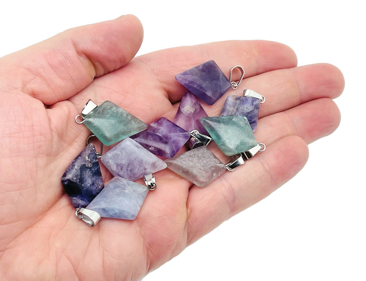 Fluorite triangle gemstone pendant with geometric design, featuring vibrant purple and green hues, by GemstoneGO.