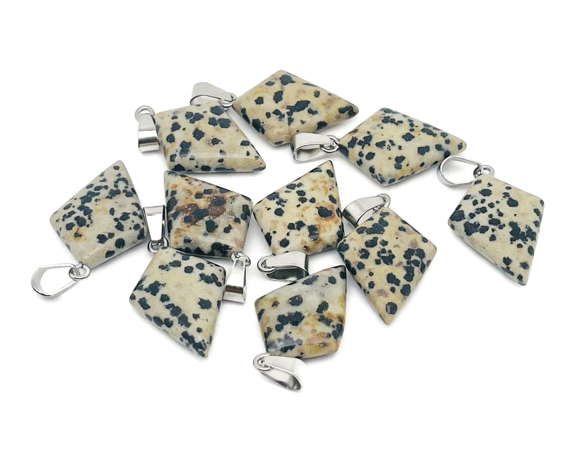 Dalmatian Jasper triangle gemstone pendant featuring a geometric design, showcasing black spots on a cream-colored stone.
