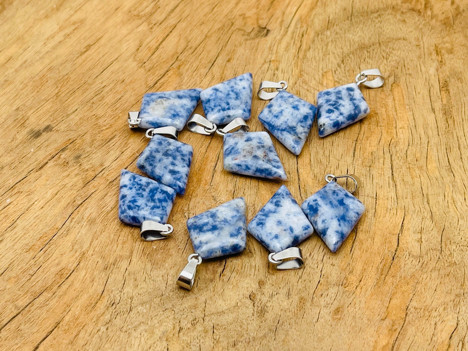 Blue Spot Jasper triangle gemstone pendant featuring a geometric design, crafted by GemstoneGO.