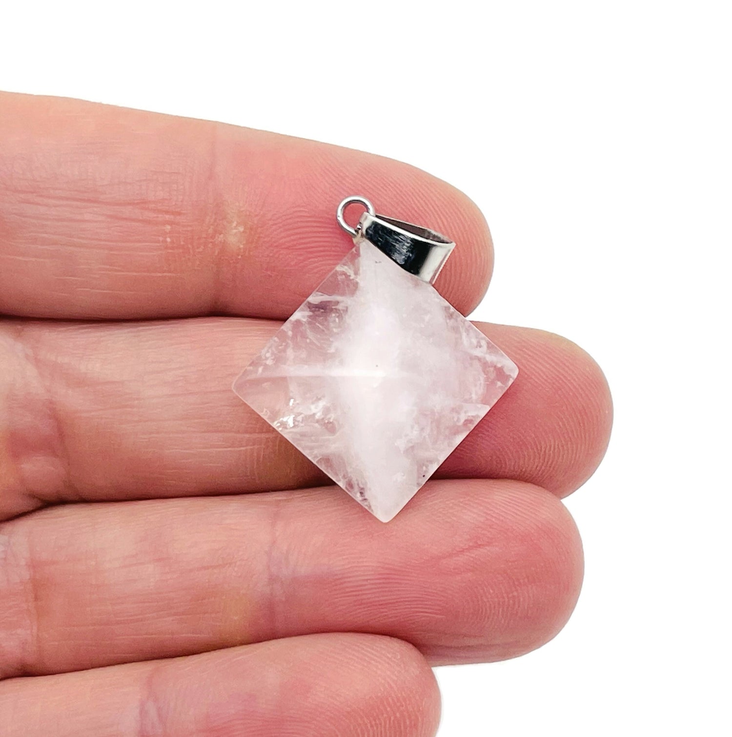 Clear quartz pyramid gemstone pendant from GemstoneGO, showcasing a natural, polished quartz pyramid on a delicate chain.