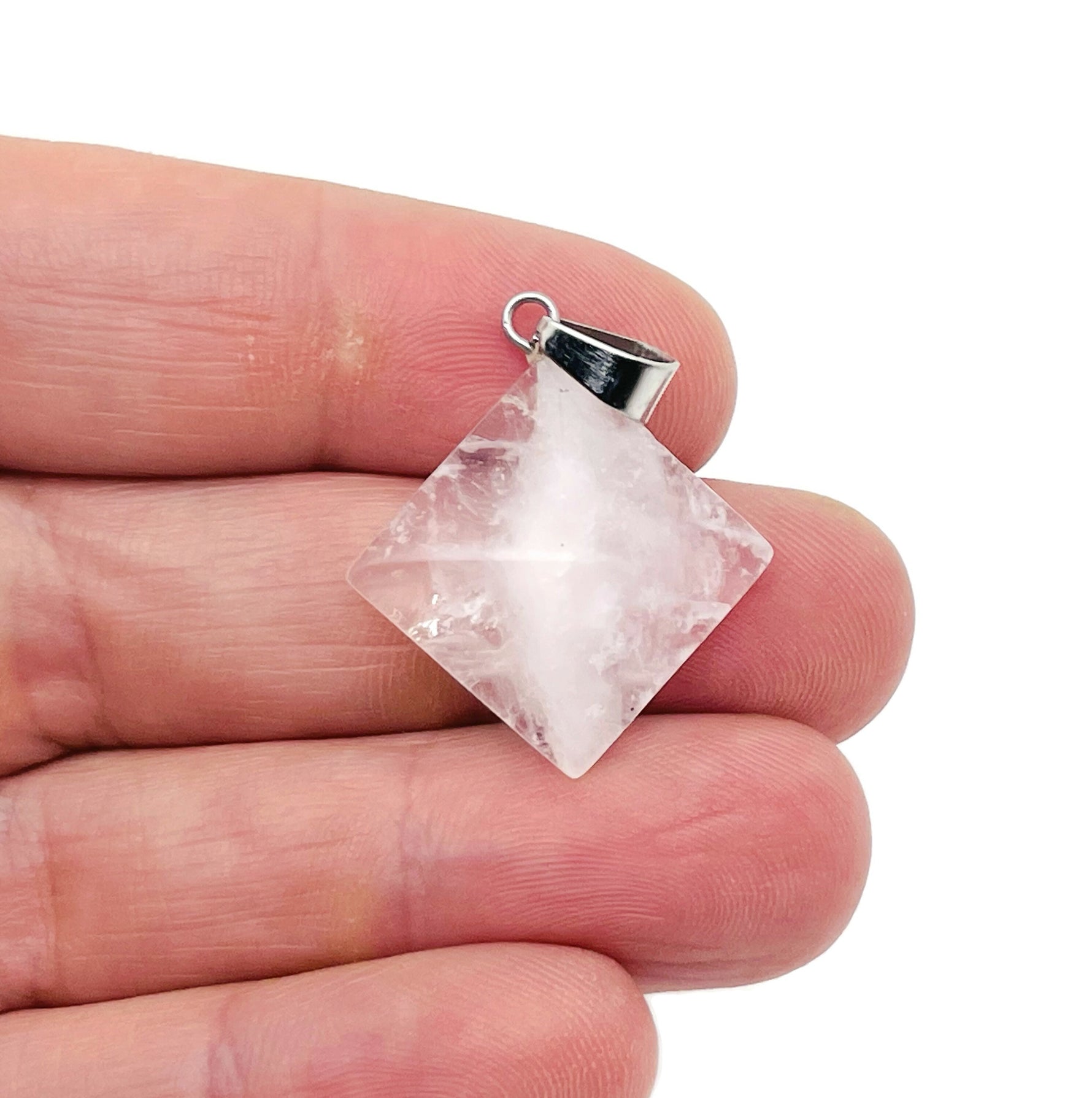 Clear quartz pyramid gemstone pendant from GemstoneGO, showcasing a natural, polished quartz pyramid on a delicate chain.