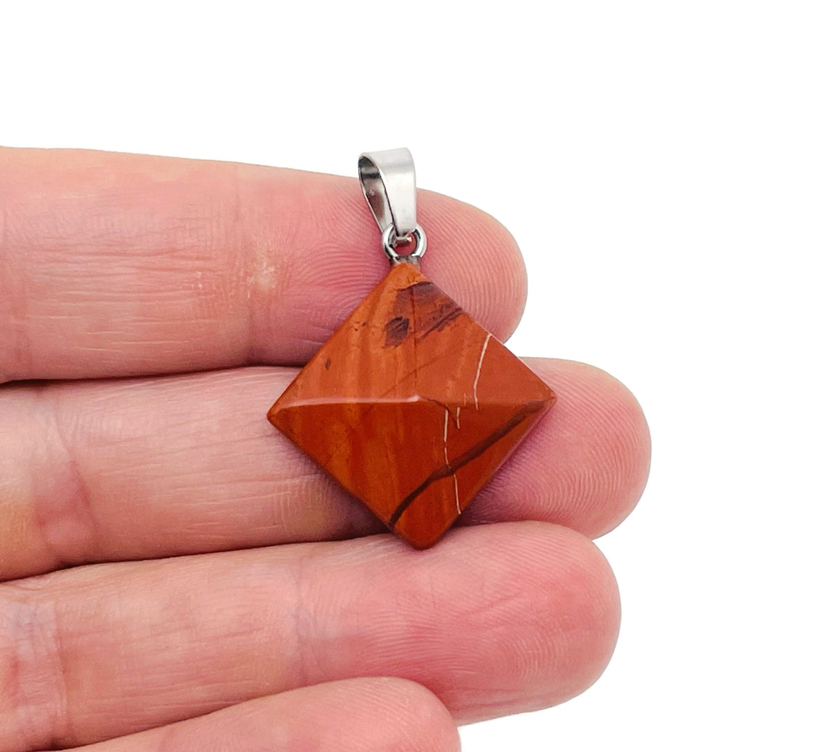 Red Jasper pyramid gemstone pendant from GemstoneGO, showcasing a natural red jasper carved pyramid pendant with detailed texture.