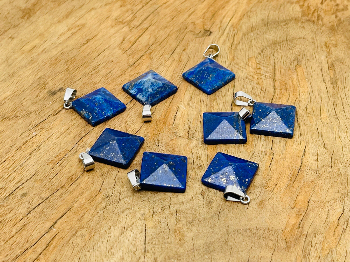 Natural lapis lazuli pyramid gemstone pendant from GemstoneGO, showcasing vibrant blue stone with gold-colored accents.