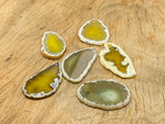 Yellow agate slice drilled pendant with natural hole, showcasing vibrant yellow color and geode-like crystal details.