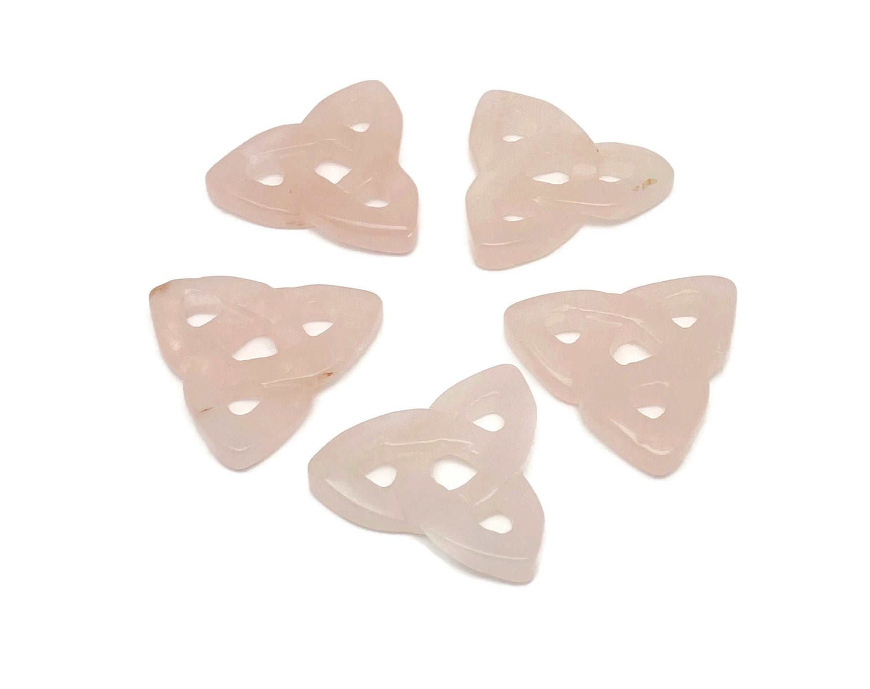 Rose quartz Celtic knot carved gemstone Trinity crystal from GemstoneGO, showcasing intricate Celtic knot design and polished pink quartz.