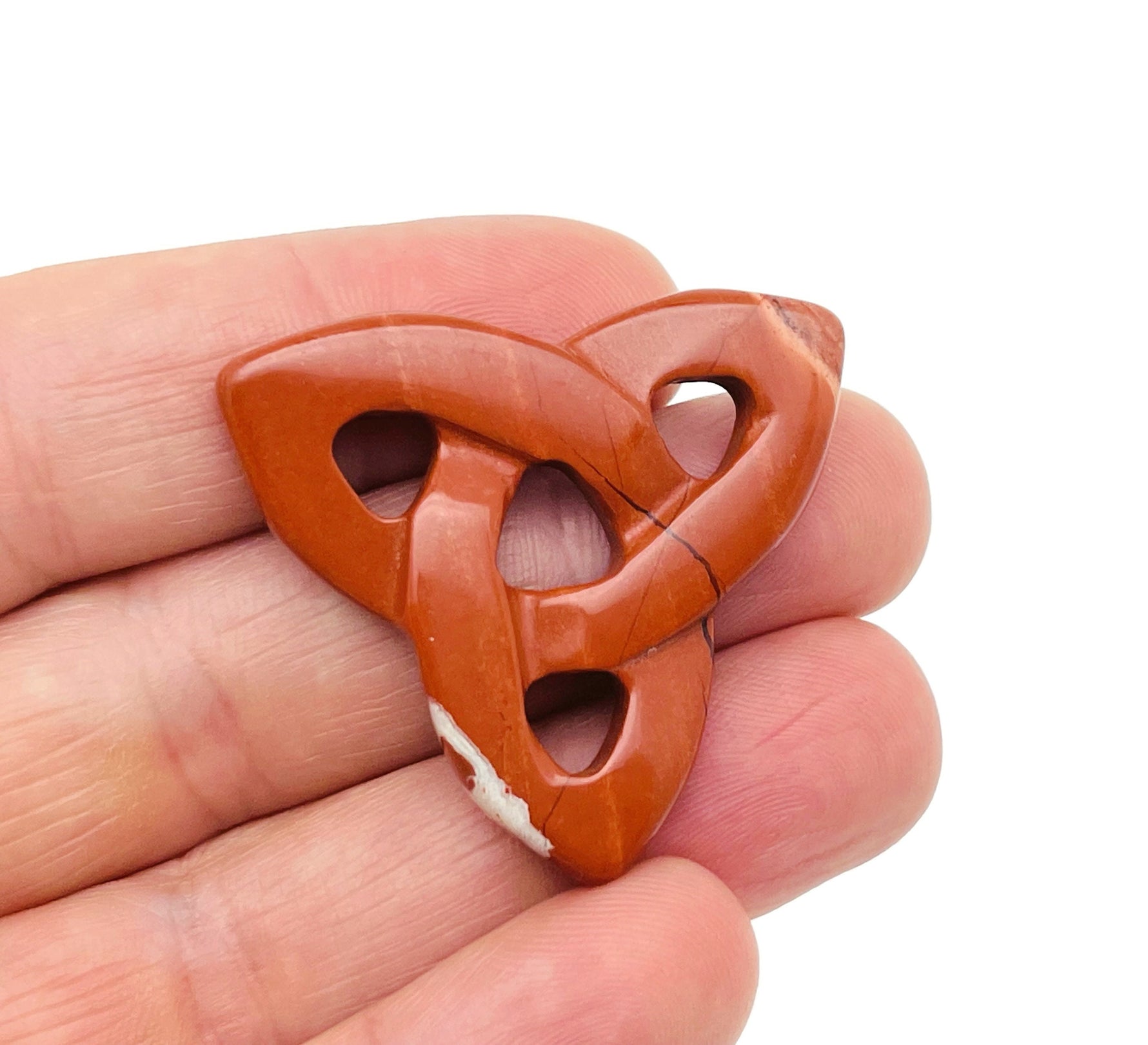 Red Jasper Celtic Knot carved gemstone pendant with Trinity Crystal design, showcasing intricate Celtic knot detailing by GemstoneGO.