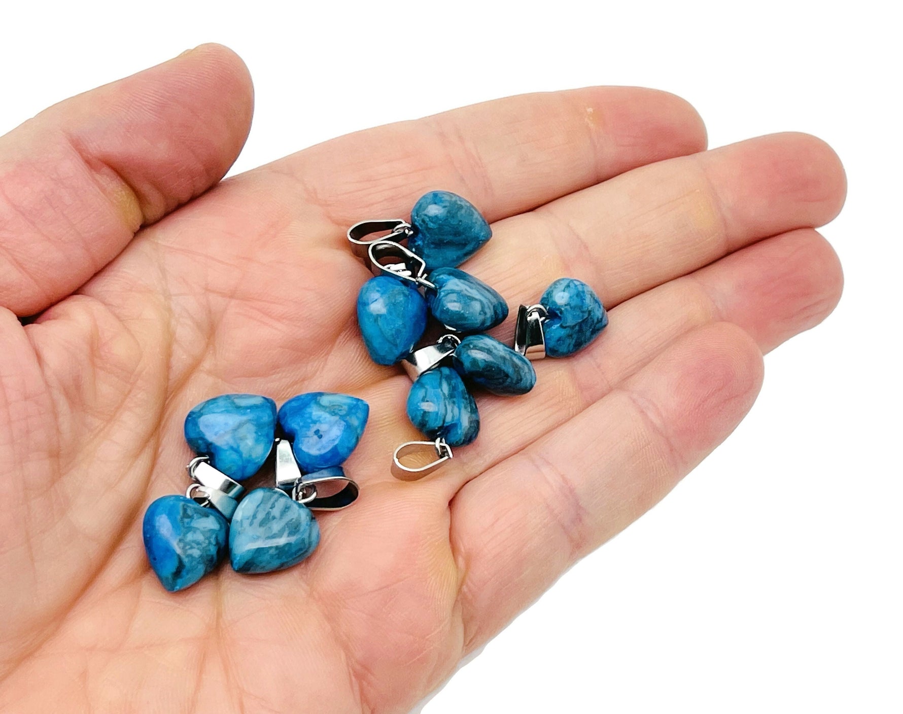 Blue Apatite heart-shaped pendant from GemstoneGO, featuring a mini crystal design, set against a neutral background.