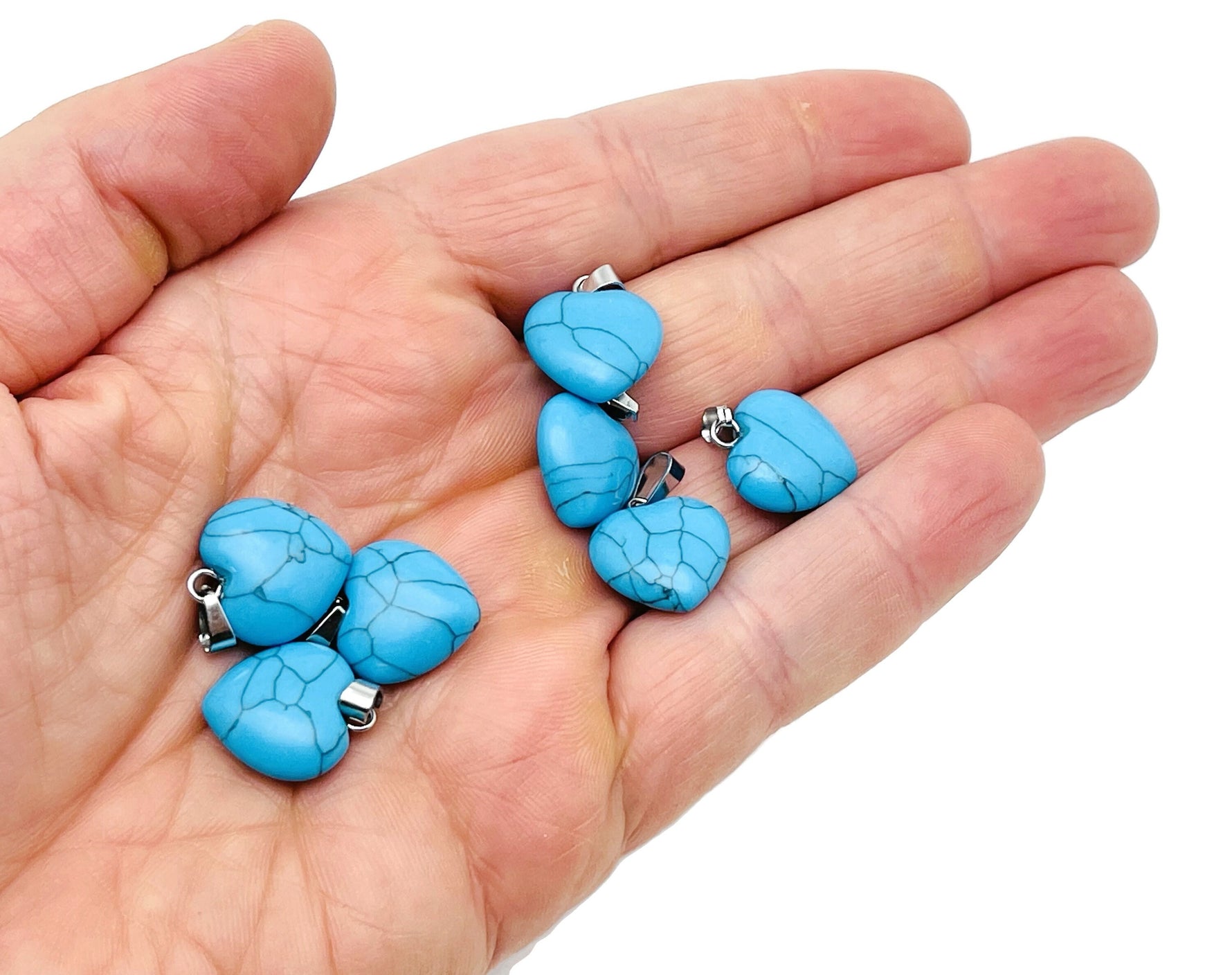 Turquoise heart-shaped pendant with mini crystal accents from GemstoneGO, showcasing detailed jewelry craftsmanship.