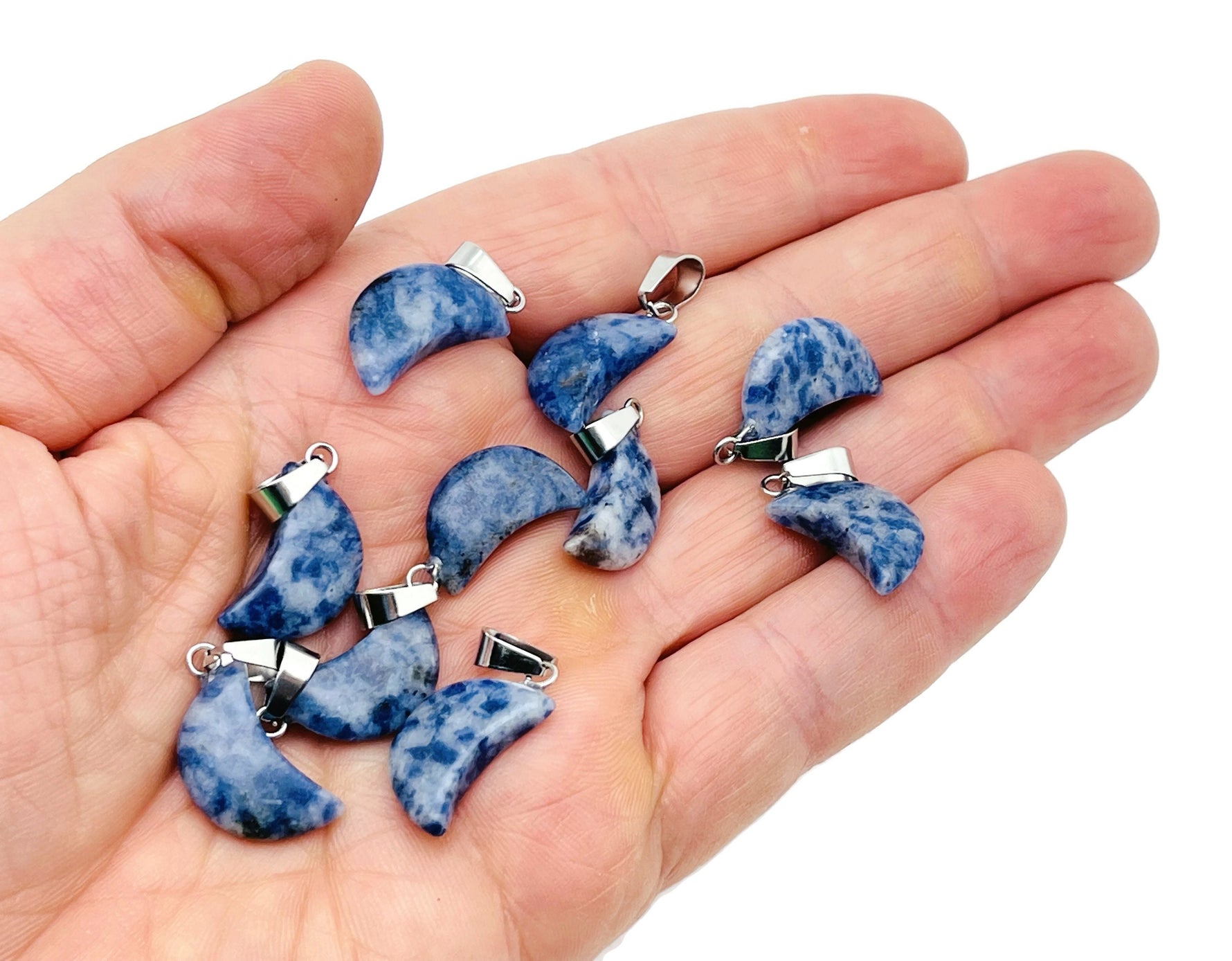 Sodalite moon-shaped crystal pendant from GemstoneGO, ideal for jewelry making, featuring a deep blue and white marbled design.