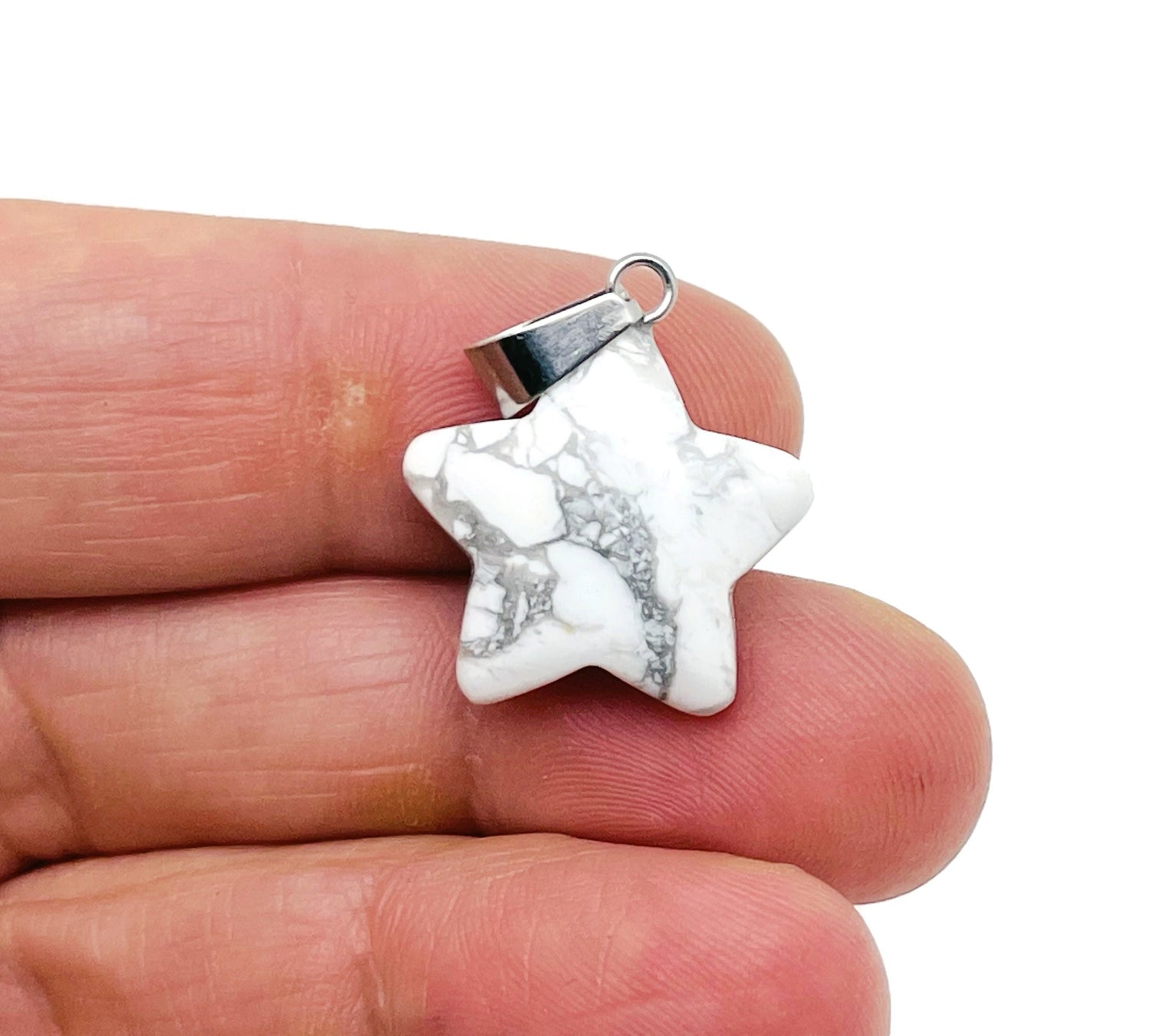 Howlite star pendant from GemstoneGO, crystal jewelry making supply, showcasing a polished white star-shaped pendant.
