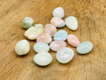 Aquamarine Morganite tumbled gemstone from GemstoneGO, showcasing smooth, polished pinkish-orange stone with natural variations.