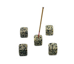 Dalmatian Jasper crystal incense holder with carved design, showcasing a smooth, polished stone for burning incense sticks.