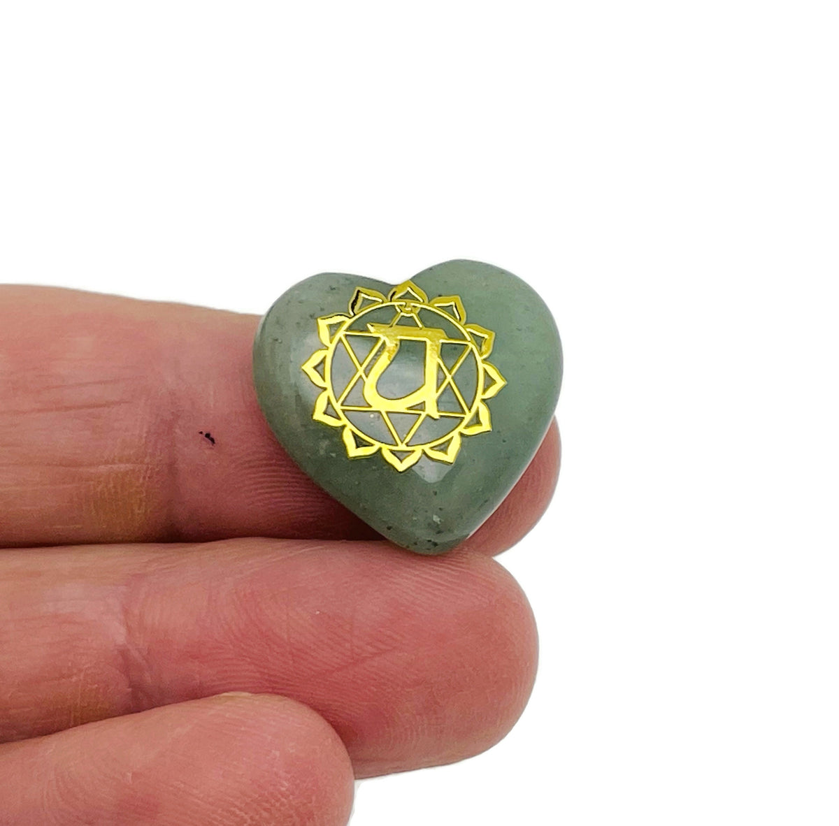 Set of seven Heart Chakra stones from GemstoneGO for meditation, featuring polished crystals arranged on a white background.