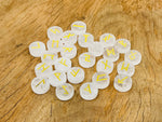 Set of 25 clear quartz crystal rune stones engraved with Elder Futhark alphabet for divination and spiritual practice.