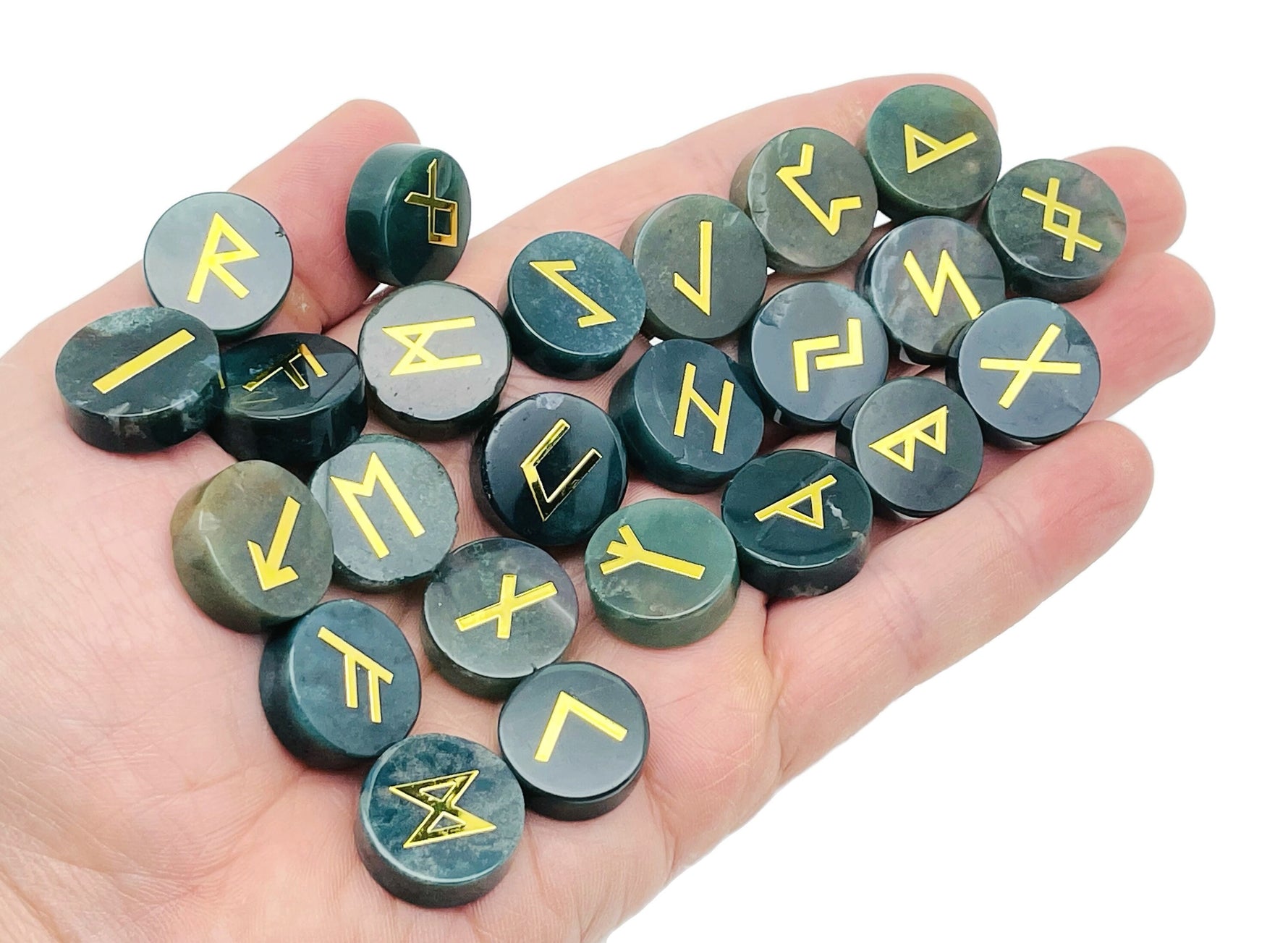 Set of 25 Moss Agate crystal rune stones engraved with Elder Futhark alphabet, part of GemstoneGO's crystal rune kit.