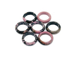Rhodonite crystal ring by GemstoneGO featuring a polished pink gemstone set in a silver band, showcasing elegant jewelry craftsmanship.