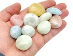 Aquamarine Morganite tumbled gemstone from GemstoneGO, smooth pinkish-orange stone with a polished surface.