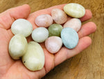 Aquamarine Morganite tumbled gemstone from GemstoneGO showing smooth, polished pinkish-blue mineral with natural variations.