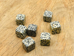 Dalmatian Jasper crystal incense holder with carved design, featuring a natural stone surface for holding incense sticks.