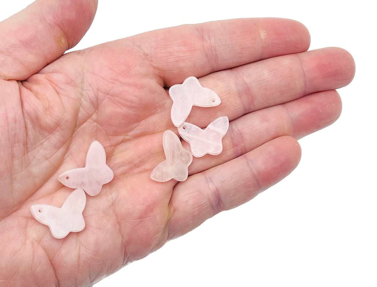 Rose quartz mini butterfly gemstone pendant with hole, crystal jewelry piece from GemstoneGO featuring a delicate butterfly design.